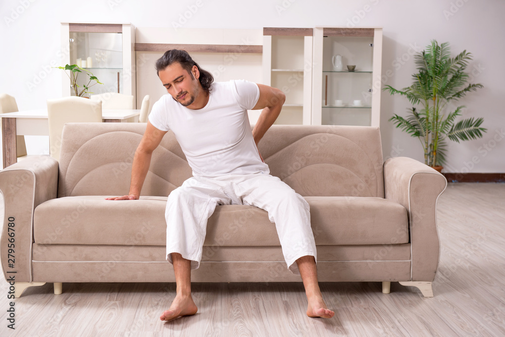 Young man doing physical exercises at home Young man doing physical exercises at home