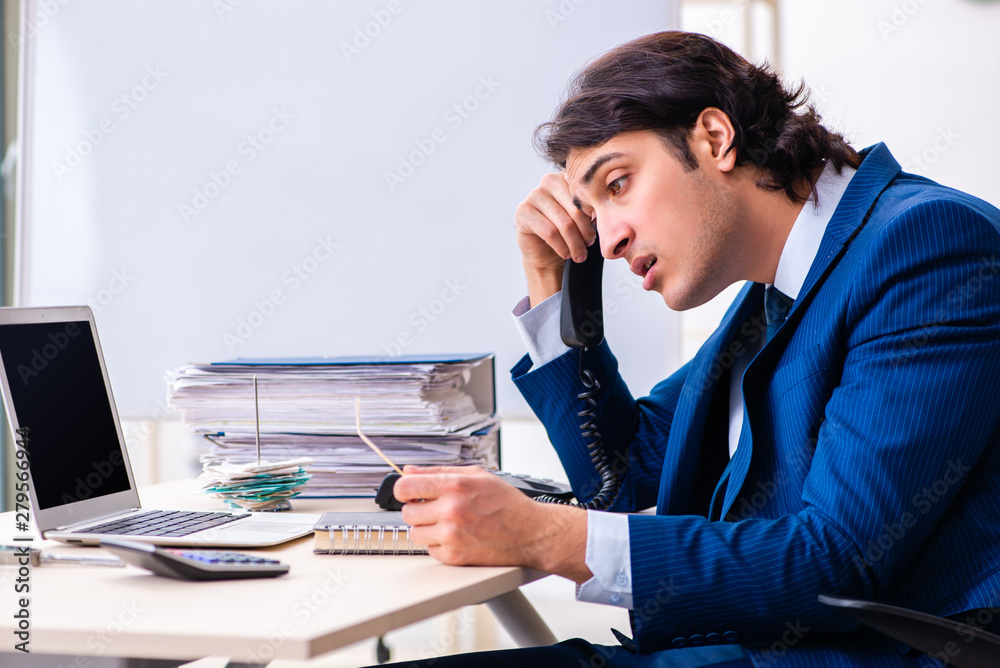 Young businessman sitting and working in the office Young businessman sitting and working in the office