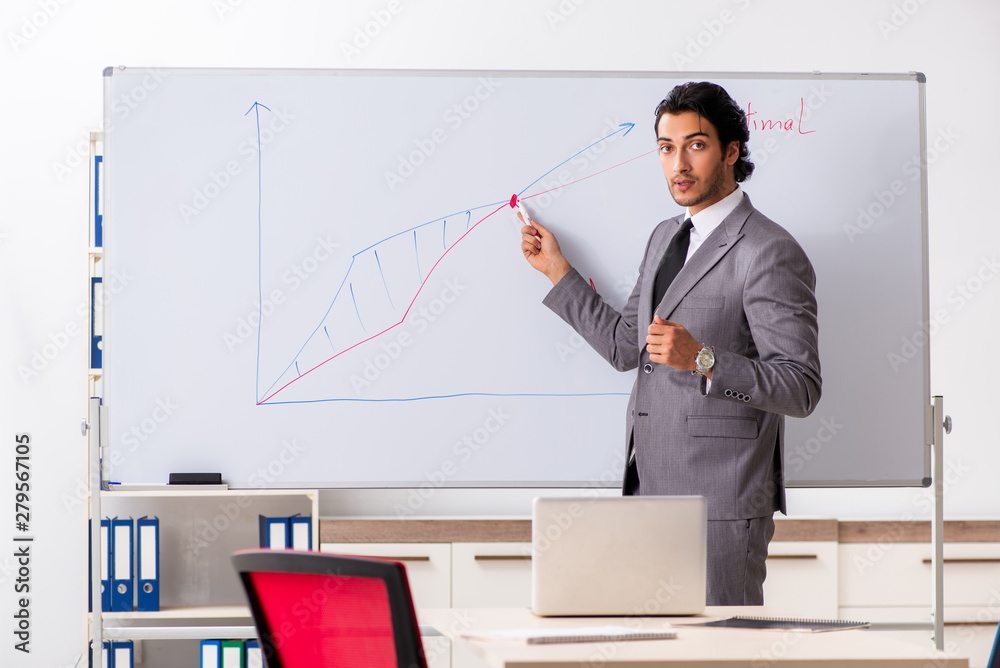 Young handsome businessman in front of whiteboard Young handsome businessman in front of whiteboard