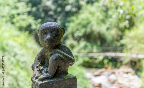 Monkey statue along the mountain road of Emei Mountain, China