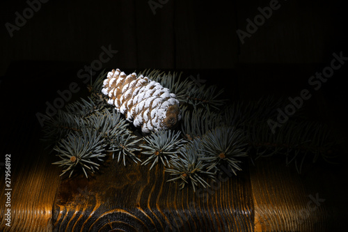 green fluffy Christmas tree, pine cone on the background of an old wooden table, rural nature, holiday cards, merry christmas and happy new year