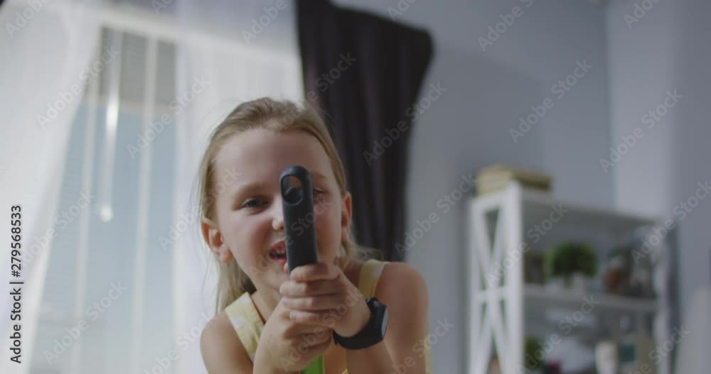 Girl singing with broom handle