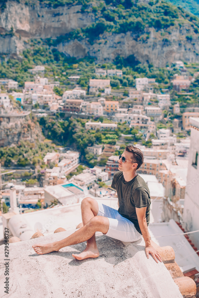 Summer holiday in Italy. Young man in Positano village on the background, Amalfi Coast, Italy