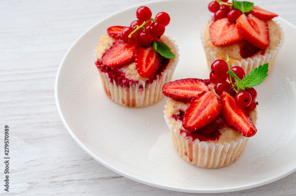 muffins decorated fresh strawberry on the plate white