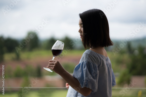 happy young cute Asian Japanese girl hipster woman guiding rest relax female travelling women drinking wine at beautiful sky mountains scenery forest jungle garden park views Kanchanaburi, Thailand.