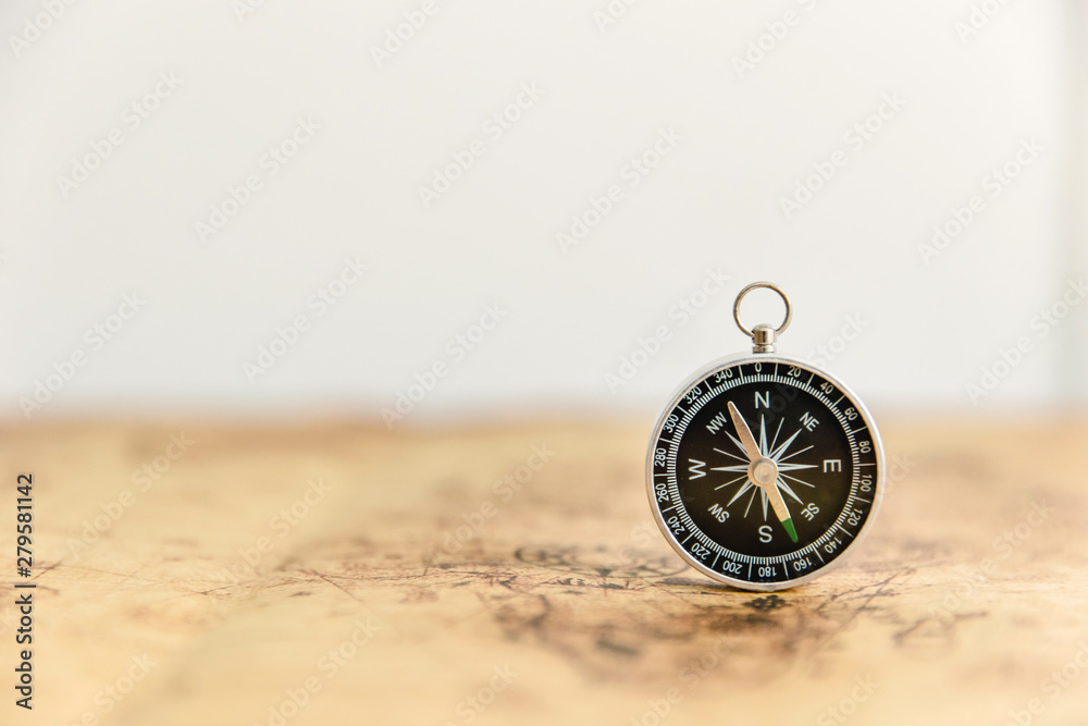 Old compass on vintage map. Retro stale.