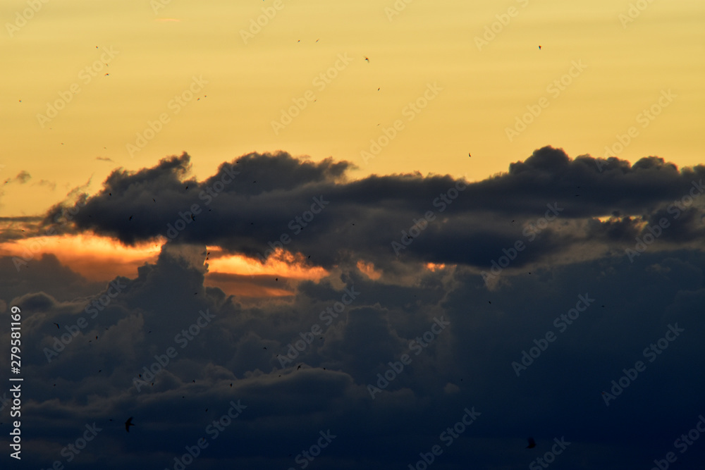 sky with clouds contrasting colors orange with dark