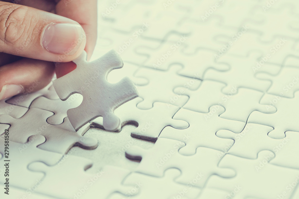 Fototapeta premium Pieces of jigsaw on palm,Pieces of jigsaw puzzle in man's hands