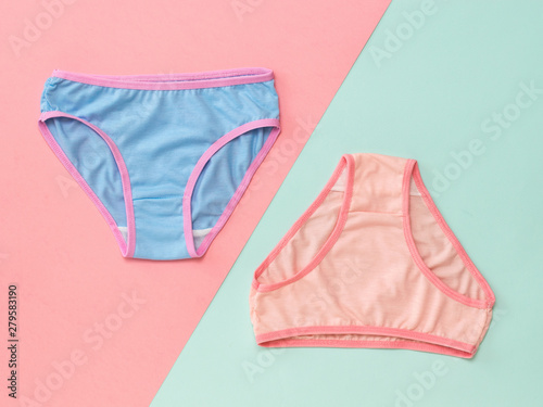 Blue and pink panties on a pink and blue background. The concept of meeting lovers. Underwear. The view from the top. photo