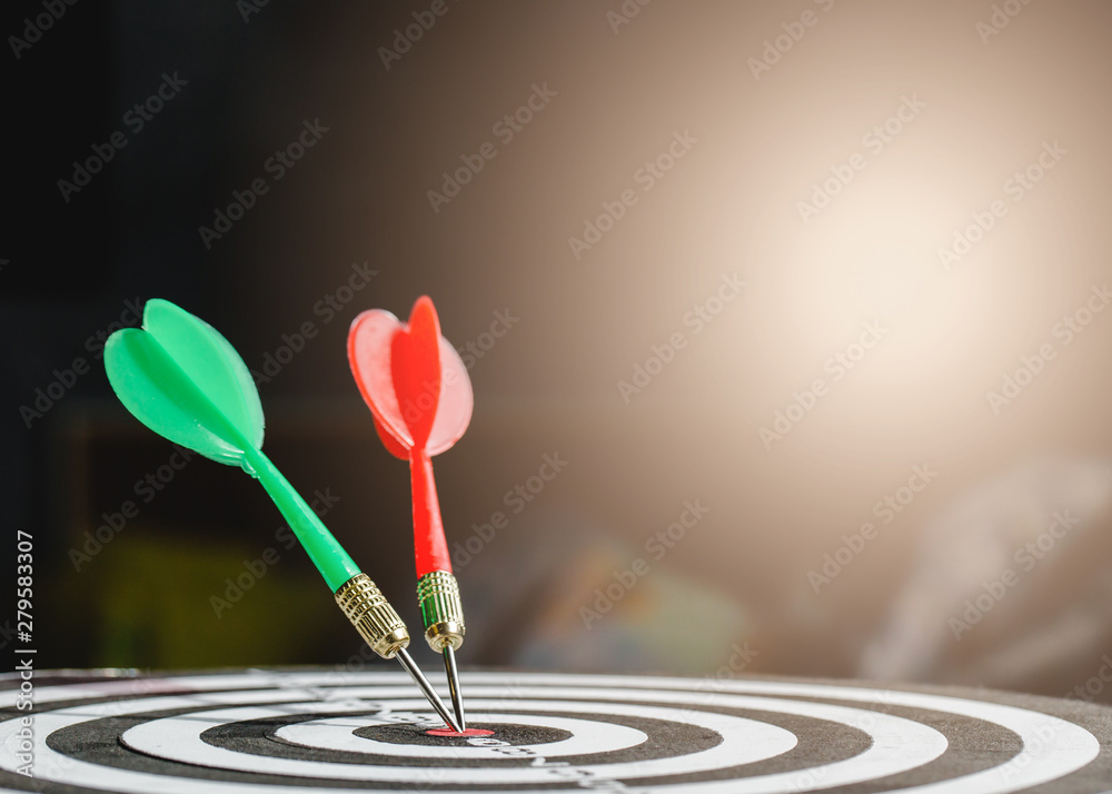 Fototapeta premium Dart arrow hitting in the target center of dartboard,business target