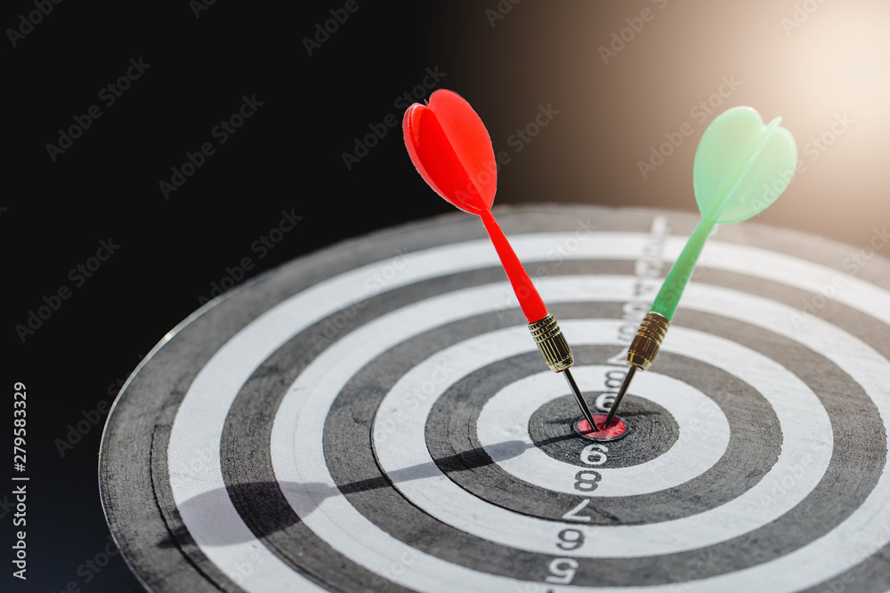 Dart arrow hitting in the target center of dartboard,business target Dart arrow hitting in the target center of dartboard,business target