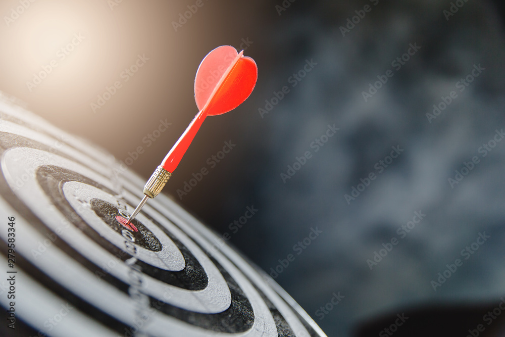 Dart arrow hitting in the target center of dartboard,business target - obrazy, fototapety, plakaty 