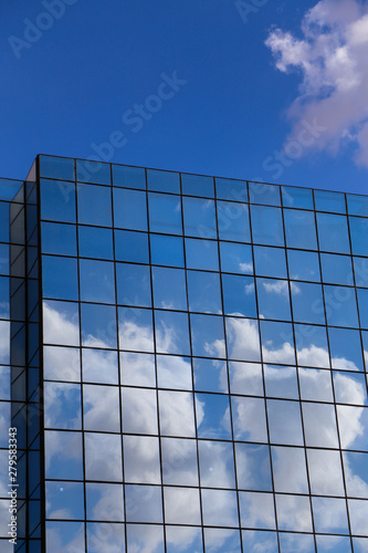 blue sky and clouds reflected in windows of modern building (ID: 279583343)