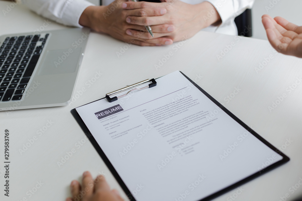Executives are interviewing job applicants and preliminary background checks, candidates are talking about their past work experience, personal managers make hiring decisions.