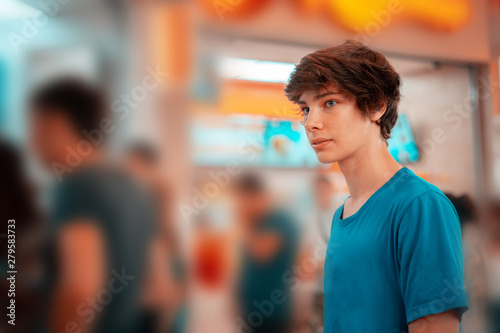 young teenager standing in a queue to receive the fastfood package