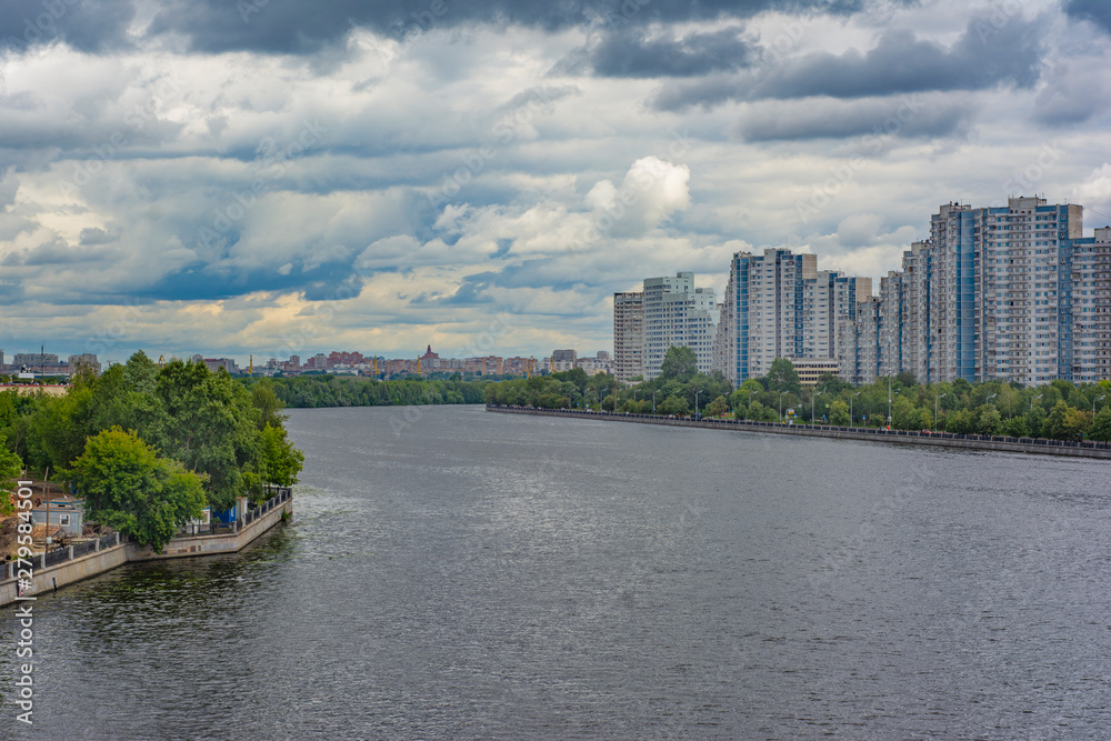 View of the floodplain with high-rise residential buildings on the embankment
