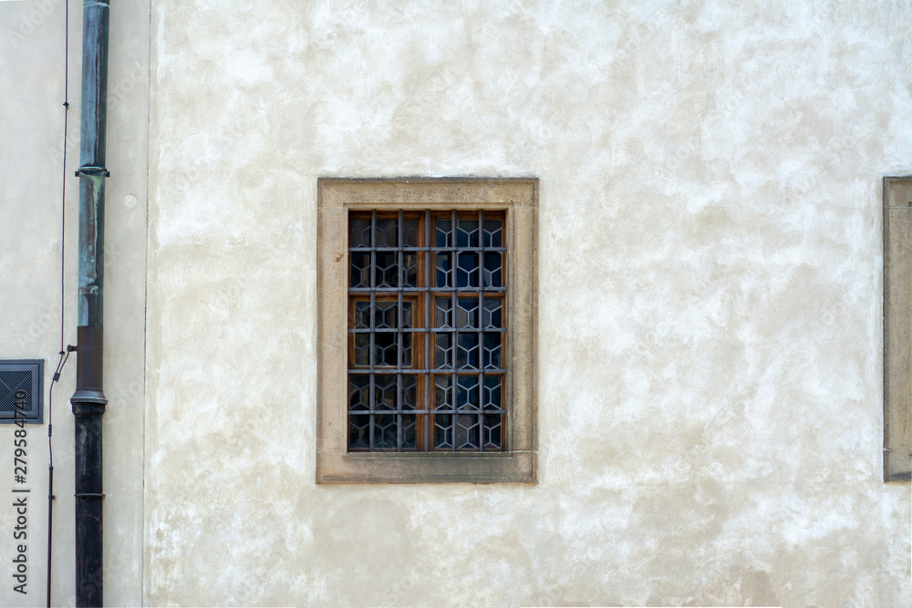 Grilled window in the plastered wall