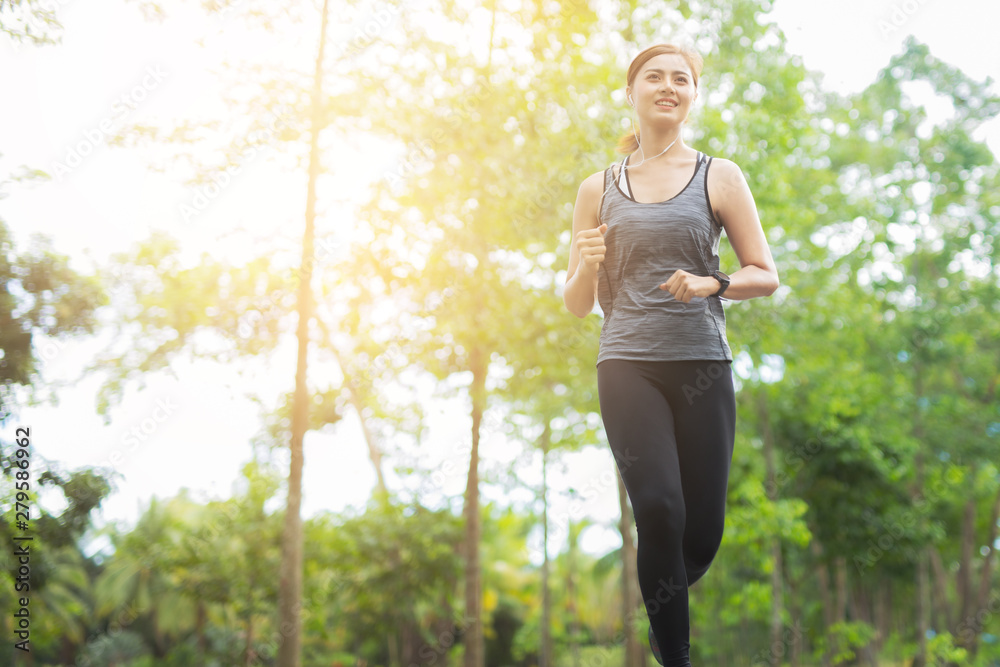 young fitness woman running at the park in morning. young fitness woman running at the park in morning.