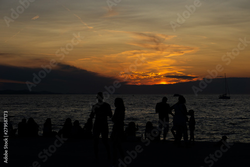 many people watch the sunset at the sea together