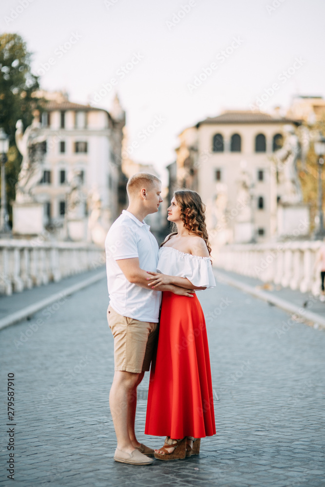 Stylish loving couple walking and laughing. Wedding shooting on the streets of Rome, Italy.