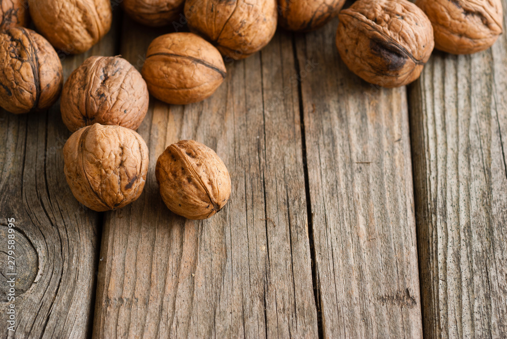 walnuts on old wooden table directly above walnuts on old wooden table directly above
