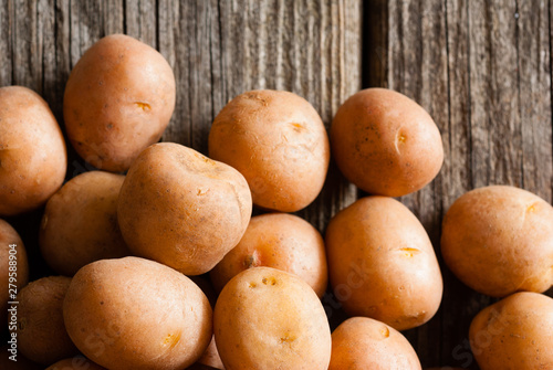 petite potatoes on rustic wood table background