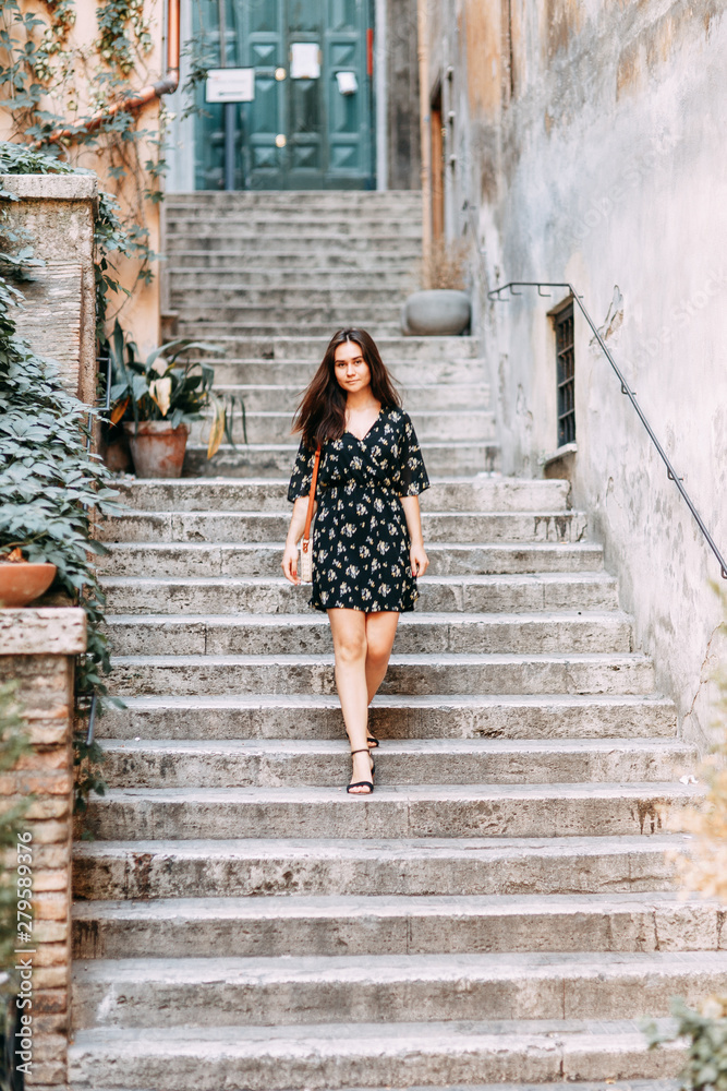 Travel blogger and sightseeing. Portraits of a beautiful girl on the streets of Rome.