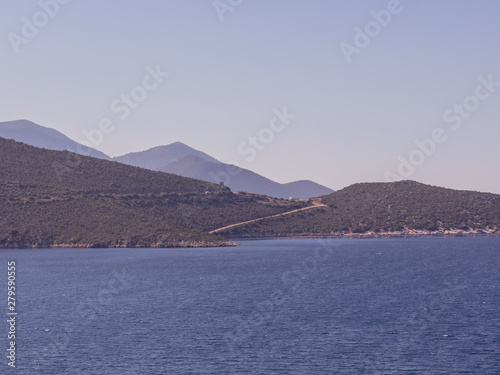 Summer time in Greece. Beautiful Greek coastline next to sea shore during warm weather. © anetlanda