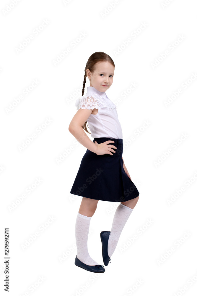 girl goes to first class .schoolgirl in school uniform on white isolated background girl goes to first class .schoolgirl in school uniform on white isolated background