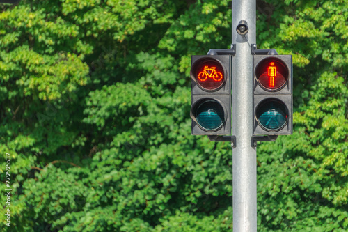 Traffic light with red little man and cyclist. Safety on the roads. Life insurance.