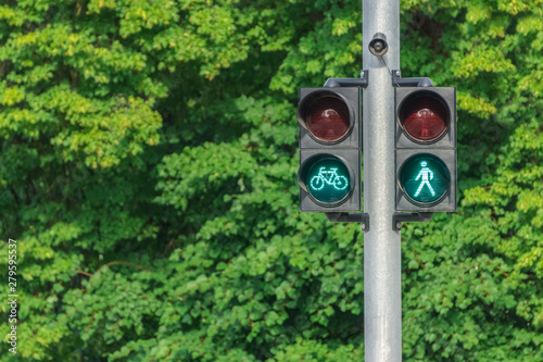 Traffic light with green little man and cyclist. Safety on the roads. Life insurance.