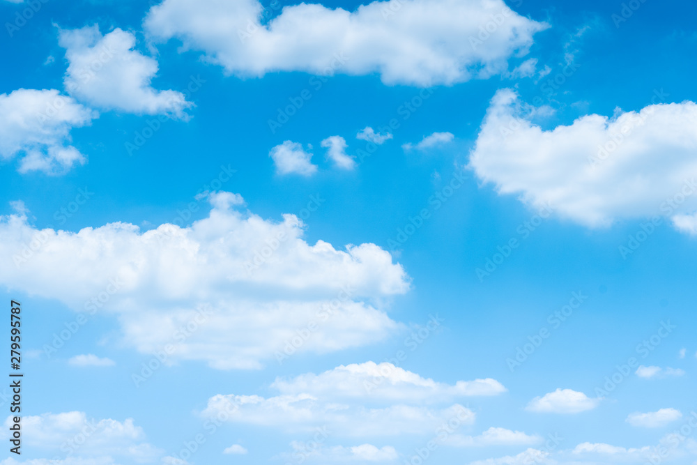 The blue sky with moving white clouds. The sky is a beautiful color shade suitable for use as a background image. The blue sky with moving white clouds. The sky is a beautiful color shade suitable for use as a background image.