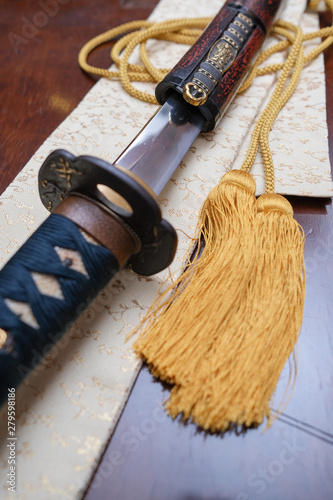 The traditional Japanese weapon is the samurai sword of katana and sheath on the table.