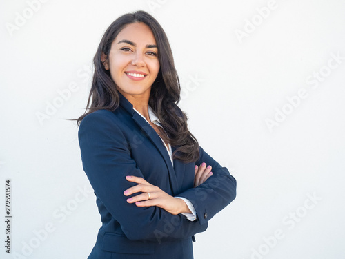 Obraz na plátně Smiling confident businesswoman posing with arms folded
