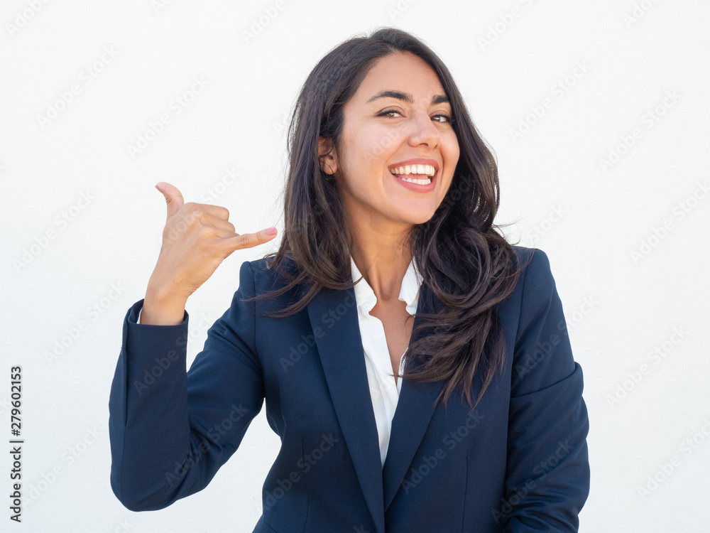 Cheerful manager making telephone gesture. Happy joyful young woman in office suit showing call me sign hands. Phone call gesture concept Cheerful manager making telephone gesture. Happy joyful young woman in office suit showing call me sign hands. Phone call gesture concept
