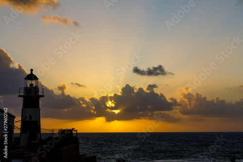 Lighthouse at sunset at crusader town Akko in Israel 