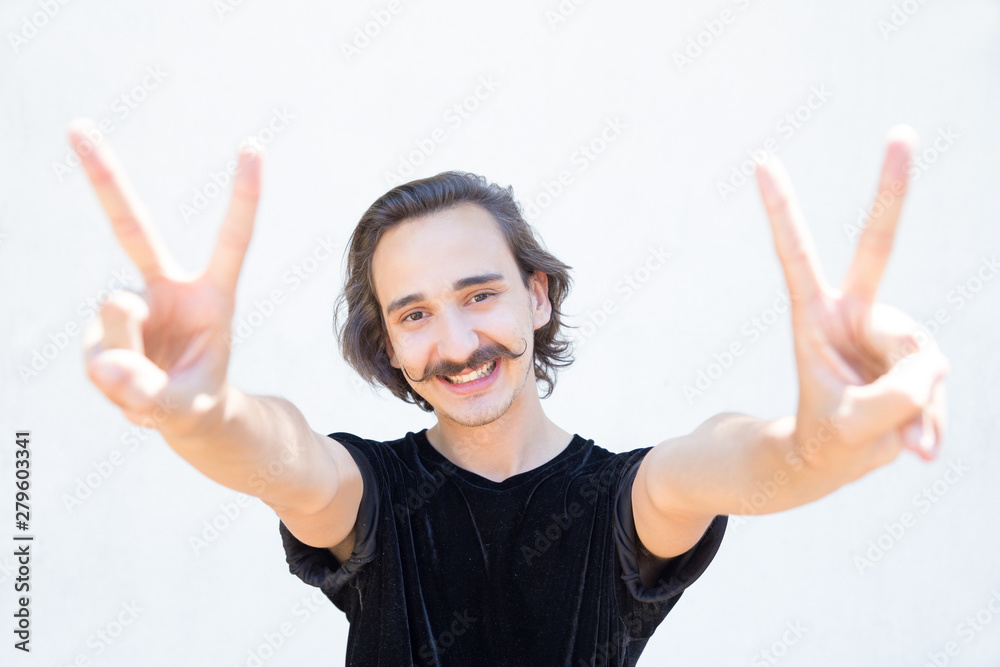 Closeup shot of smiling man with mustache showing peace signs. Cheerful stylish guy gesturing. Concept of gesture Closeup shot of smiling man with mustache showing peace signs. Cheerful stylish guy gesturing. Concept of gesture