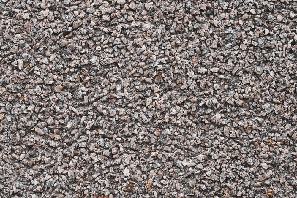 Background of small brown and gray pebbles. Rough stone wall, abstract pattern. Surface, rock texture. Background of small brown and gray pebbles. Rough stone wall, abstract pattern. Surface, rock texture.