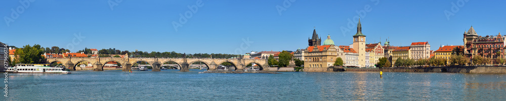 Autumn panorama of Charles Bridge and riverside in Prague
