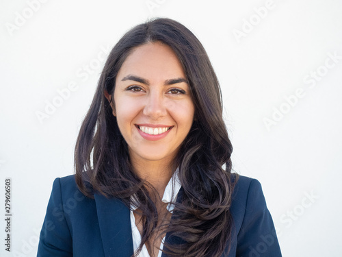 Tableau sur toile Happy successful businesswoman smiling at camera over white studio background