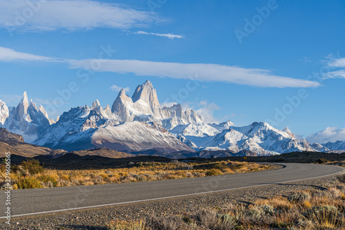 Beautiful Fitz Roy and Cerro Torre peak snow mountain in the morning blue sky with golden yellow grass beside the asphalt road route 40 road from El Calafate to El Chalten, south Patagonia, Argentina photo