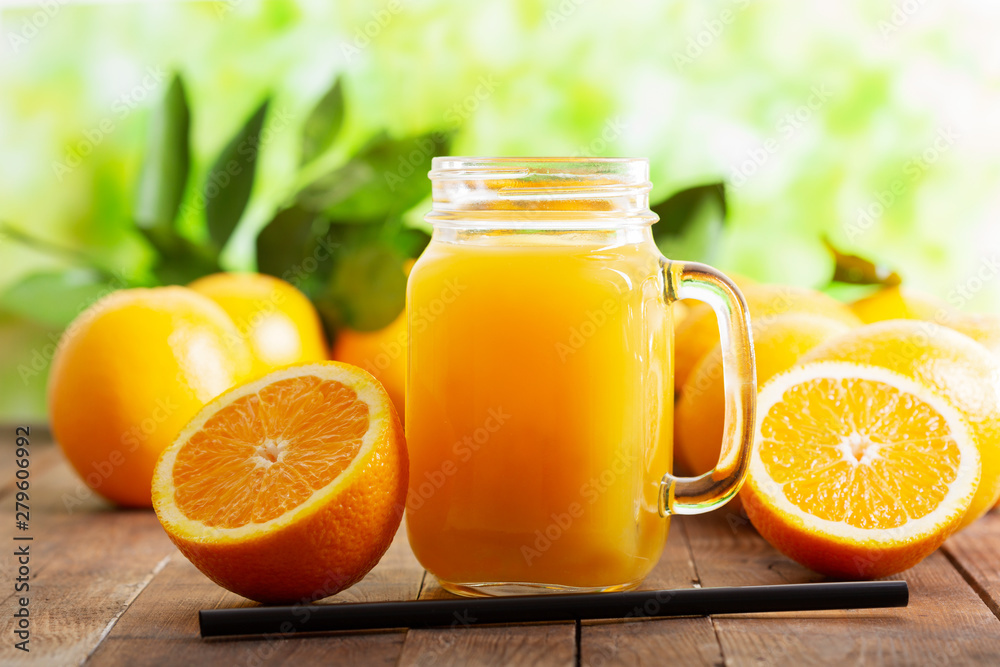glass jar of fresh orange juice with fresh fruits