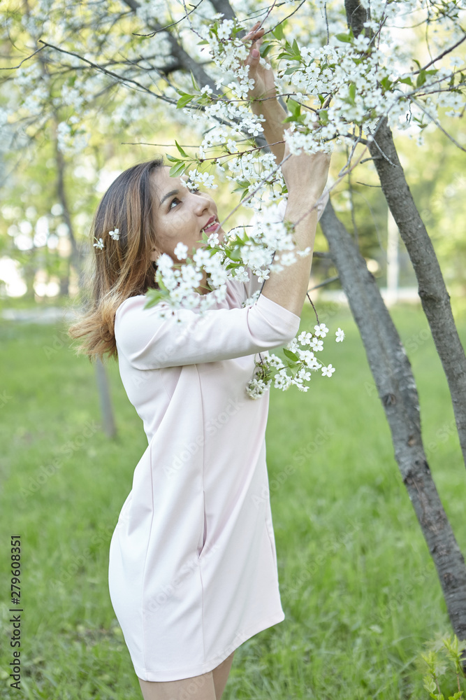 girl with flowers. gorgeous model in the spring garden. the girl near the tree in the spring. girl with flowers. gorgeous model in the spring garden. the girl near the tree in the spring.