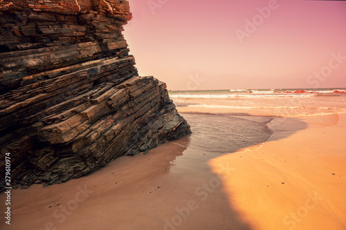 Rocky coast after sunrise. Natural landscape. Rock on the beach early in the morning. Beach at low tide © vvvita
