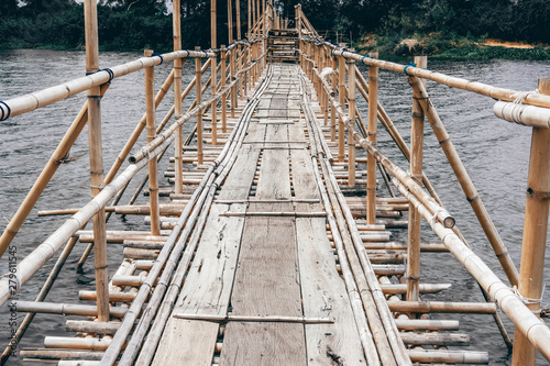 Fototapeta Naklejka Na Ścianę i Meble -  wooden bridge footbridge walkway crossing river