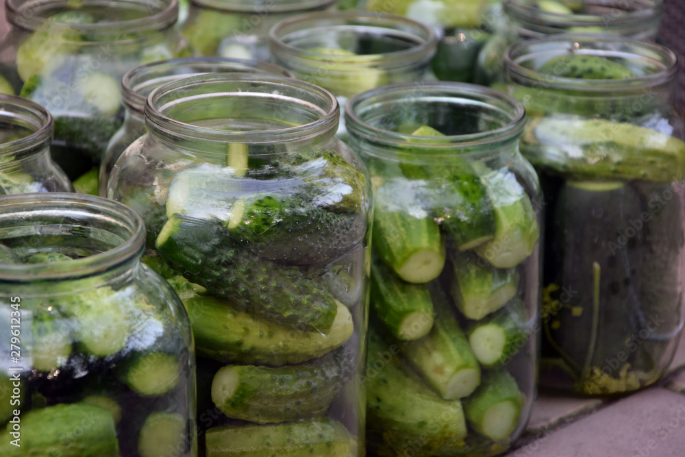 The photo shows cucumbers in the bank prepared for preservation. The photo shows cucumbers in the bank prepared for preservation.