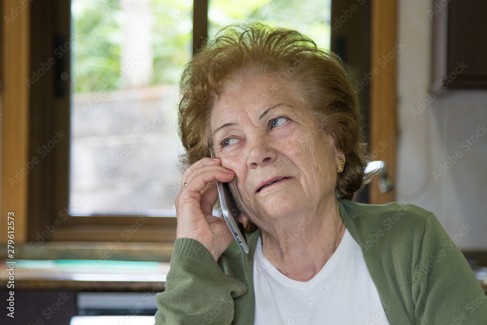 senior woman talking on a cell phone senior woman talking on a cell phone