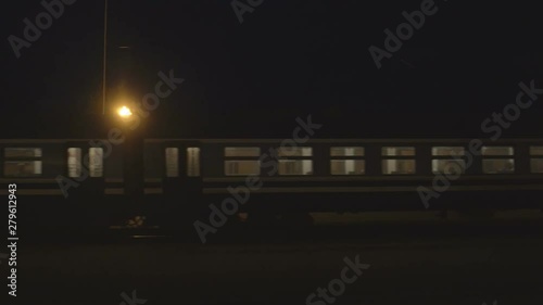 Passenger train leaves the railway station at night, the background, copy space, railroad station photo