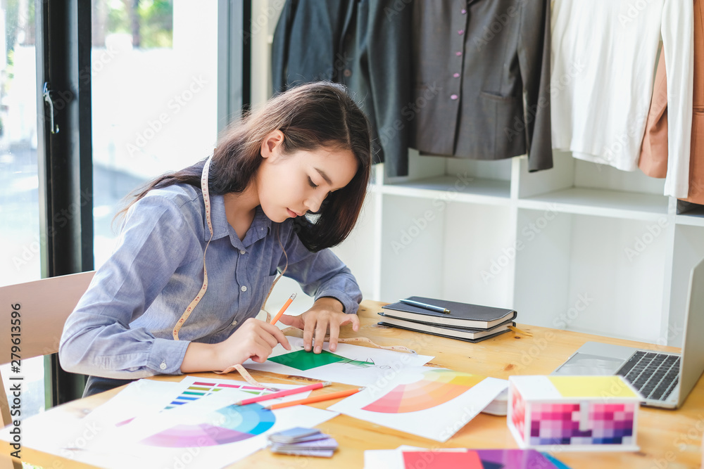 Asian woman fashion designer work at home happily. Internship designer about fashion clothing. Asian woman fashion designer work at home happily. Internship designer about fashion clothing.
