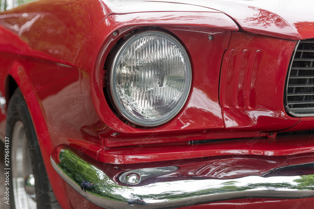 Headlight of the red retro car. Front light